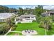 A luxurious backyard with a pool, outdoor kitchen, fire pit, and beautiful landscaping for outdoor enjoyment at 7145 Lake Dr, Orlando, FL 32809