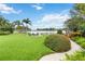 Well-maintained backyard with lush grass, firepit, and scenic waterfront view at 7145 Lake Dr, Orlando, FL 32809