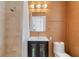 Modern bathroom featuring vanity, shower, and toilet with a stylish finish at 7145 Lake Dr, Orlando, FL 32809