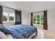 Cozy bedroom featuring a floral duvet cover and two large windows at 7145 Lake Dr, Orlando, FL 32809