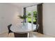 Bright breakfast nook with a round table and chairs next to a window with a view of the yard at 7145 Lake Dr, Orlando, FL 32809