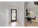 Bright entryway with modern door, travertine floors, leading to an adjacent dining area at 7145 Lake Dr, Orlando, FL 32809