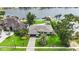 A charming single-story home with lush landscaping, a paved driveway, and views of the waterfront at 7145 Lake Dr, Orlando, FL 32809