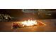 Atmospheric fire pit with built-in seating on a stone patio at 7145 Lake Dr, Orlando, FL 32809