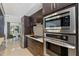 Modern kitchen with stainless steel appliances, dark wood cabinets, and bright breakfast nook at 7145 Lake Dr, Orlando, FL 32809