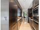 Modern kitchen featuring stainless steel appliances, dark wood cabinets, and travertine flooring at 7145 Lake Dr, Orlando, FL 32809