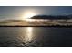 Scenic view of the lake at sunset with sun rays breaking through the clouds at 7145 Lake Dr, Orlando, FL 32809