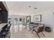 Open living room with travertine flooring, stylish seating, bar, and water views at 7145 Lake Dr, Orlando, FL 32809