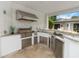 A luxurious outdoor kitchen featuring stainless steel appliances, counter seating and a granite counter top at 7145 Lake Dr, Orlando, FL 32809