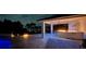 An outdoor kitchen and lakefront patio featuring elegant lighting and water views at 7145 Lake Dr, Orlando, FL 32809