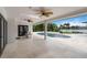 Covered patio area showcasing ceiling fans and panoramic views of the pool and lush landscaping at 7145 Lake Dr, Orlando, FL 32809