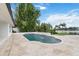 An outdoor pool with fountains and a patio surrounded by lush, tropical landscaping at 7145 Lake Dr, Orlando, FL 32809