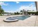 An outdoor pool with fountains and an attached hot tub with a view of the lake at 7145 Lake Dr, Orlando, FL 32809