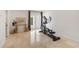 Bright room with marble tile floor, exercise bike, glass table and view to the patio at 7145 Lake Dr, Orlando, FL 32809