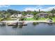 A serene waterfront property with a private beach, boat docks, and meticulously manicured lawns at 7145 Lake Dr, Orlando, FL 32809