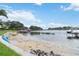 Sandy waterfront with lush landscaping and a dock at 7145 Lake Dr, Orlando, FL 32809