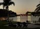 Enjoy seating area on the waterfront with a view of a bridge illuminated with colorful lights at 7145 Lake Dr, Orlando, FL 32809