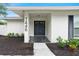 Inviting front entrance with double doors, decorative black tile, and fresh landscape at 7446 Houston E Ct, Winter Park, FL 32792
