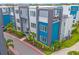 Aerial view of modern townhomes with contemporary design, highlighted by colorful accents and lush landscaping at 7740 Sandy Ridge Dr # 124, Reunion, FL 34747