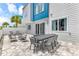 Inviting outdoor patio featuring a dining table, lounge chairs, and well-maintained pavers at 7740 Sandy Ridge Dr # 124, Reunion, FL 34747