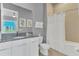 Clean bathroom with a large mirror, neutral color scheme, and modern fixtures at 7740 Sandy Ridge Dr # 124, Reunion, FL 34747