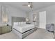 Comfortable bedroom featuring a tufted headboard, soft lighting, and an ensuite bathroom at 7740 Sandy Ridge Dr # 124, Reunion, FL 34747