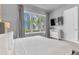 Bedroom showcasing a large window with exterior views and a wall-mounted TV at 7740 Sandy Ridge Dr # 124, Reunion, FL 34747
