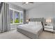 Inviting bedroom featuring a large window with exterior views and neutral decor at 7740 Sandy Ridge Dr # 124, Reunion, FL 34747