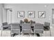 Elegant dining room with modern decor, sleek furnishings, and stylish wall art at 7740 Sandy Ridge Dr # 124, Reunion, FL 34747