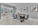 Bright dining area with neutral color palette, sliding door access to outdoor patio at 7740 Sandy Ridge Dr # 124, Reunion, FL 34747