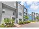 Stylish modern townhome showcasing vibrant blue accents, well-manicured landscaping, and inviting entrance at 7740 Sandy Ridge Dr # 124, Reunion, FL 34747