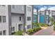 Modern townhomes with stylish design, featuring lush landscaping and contemporary architectural elements at 7740 Sandy Ridge Dr # 124, Reunion, FL 34747