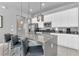 Modern kitchen featuring a large island, stainless steel appliances, and stylish pendant lighting at 7740 Sandy Ridge Dr # 124, Reunion, FL 34747
