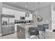 Contemporary kitchen showcasing a stainless steel refrigerator, large island, and modern pendant lights at 7740 Sandy Ridge Dr # 124, Reunion, FL 34747