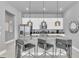 Stylish kitchen featuring a large island with seating, pendant lighting, and modern appliances at 7740 Sandy Ridge Dr # 124, Reunion, FL 34747