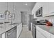 Bright kitchen with stainless steel appliances, sleek white cabinets, and a spacious center island at 7740 Sandy Ridge Dr # 124, Reunion, FL 34747