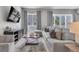 Well-lit living room with cozy seating, stylish rug, and view of the outdoors at 7740 Sandy Ridge Dr # 124, Reunion, FL 34747