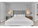 Comfortable main bedroom with luxurious, tufted headboard, decorative wall art and soft, neutral color palette at 7740 Sandy Ridge Dr # 124, Reunion, FL 34747