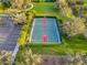 Aerial view of a basketball court surrounded by manicured landscaping, parking, and green space in a community at 7918 Esta Ln, Orlando, FL 32827
