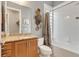 Bathroom with granite countertop, framed mirror, and tiled shower-tub combo at 7918 Esta Ln, Orlando, FL 32827