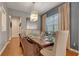 Formal dining room with hardwood floors, modern chandelier, and seating for eight guests at 7918 Esta Ln, Orlando, FL 32827