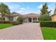 Charming single-story home with a brick driveway and beautifully landscaped front yard at 7918 Esta Ln, Orlando, FL 32827