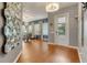Welcoming foyer with hardwood floors, chandelier, and decorative mirror at 7918 Esta Ln, Orlando, FL 32827