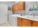 Bright laundry room featuring side-by-side washer and dryer and wooden cabinets at 7918 Esta Ln, Orlando, FL 32827
