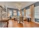 Elegant living room with hardwood floors, large windows, and stylish furnishings at 7918 Esta Ln, Orlando, FL 32827