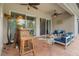 Relaxing covered patio featuring brick floors, ceiling fans, and comfortable seating area with a bar for entertaining at 7918 Esta Ln, Orlando, FL 32827