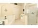 Bright bathroom featuring soaking tub, glass-enclosed shower and closet space at 8093 Indian Creek Blvd, Kissimmee, FL 34747