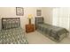 Comfortable bedroom featuring two twin size beds with a shared bedside table and lamp at 8093 Indian Creek Blvd, Kissimmee, FL 34747