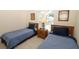 Comfortable bedroom featuring two twin size beds with a shared bedside table and lamp at 8093 Indian Creek Blvd, Kissimmee, FL 34747