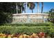 Stone entrance sign to Indian Creek community with lush landscaping at 8093 Indian Creek Blvd, Kissimmee, FL 34747